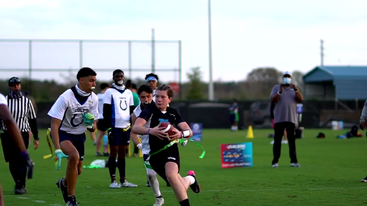 A ball carrier running past two defenders